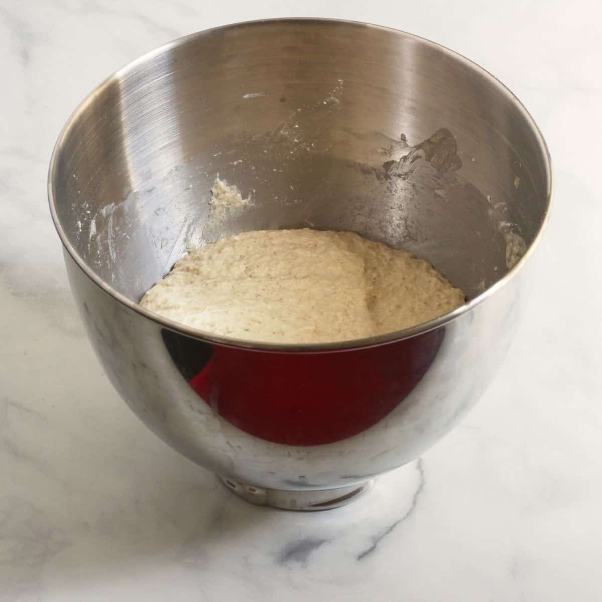 soft, sticky dough in the bowl of a stand mixer.