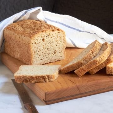 sliced bread on wooden board.