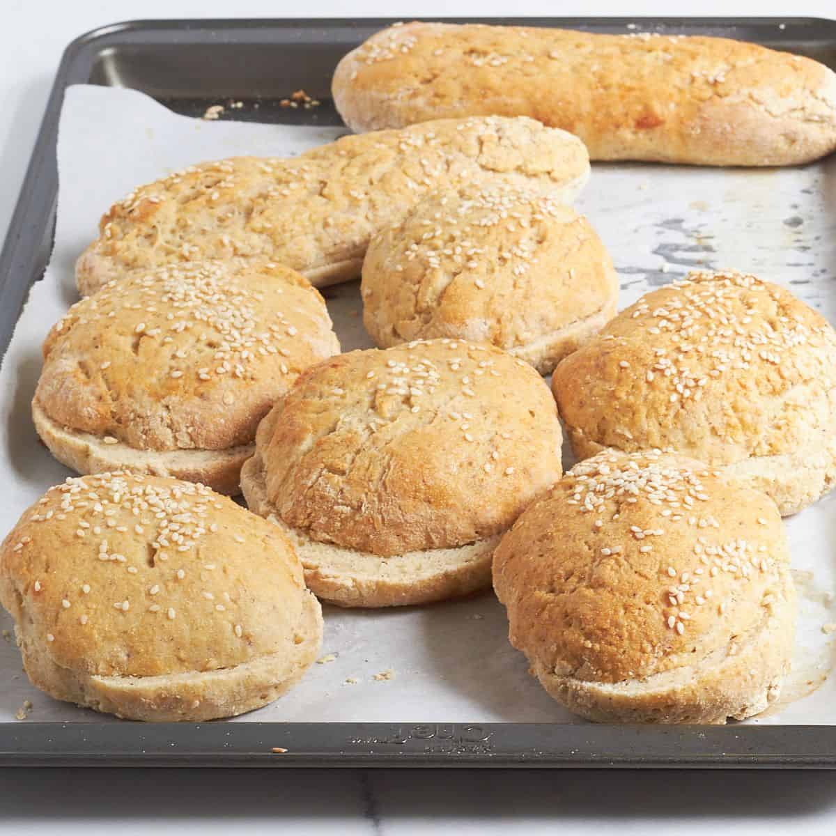sliced burger buns on tray.