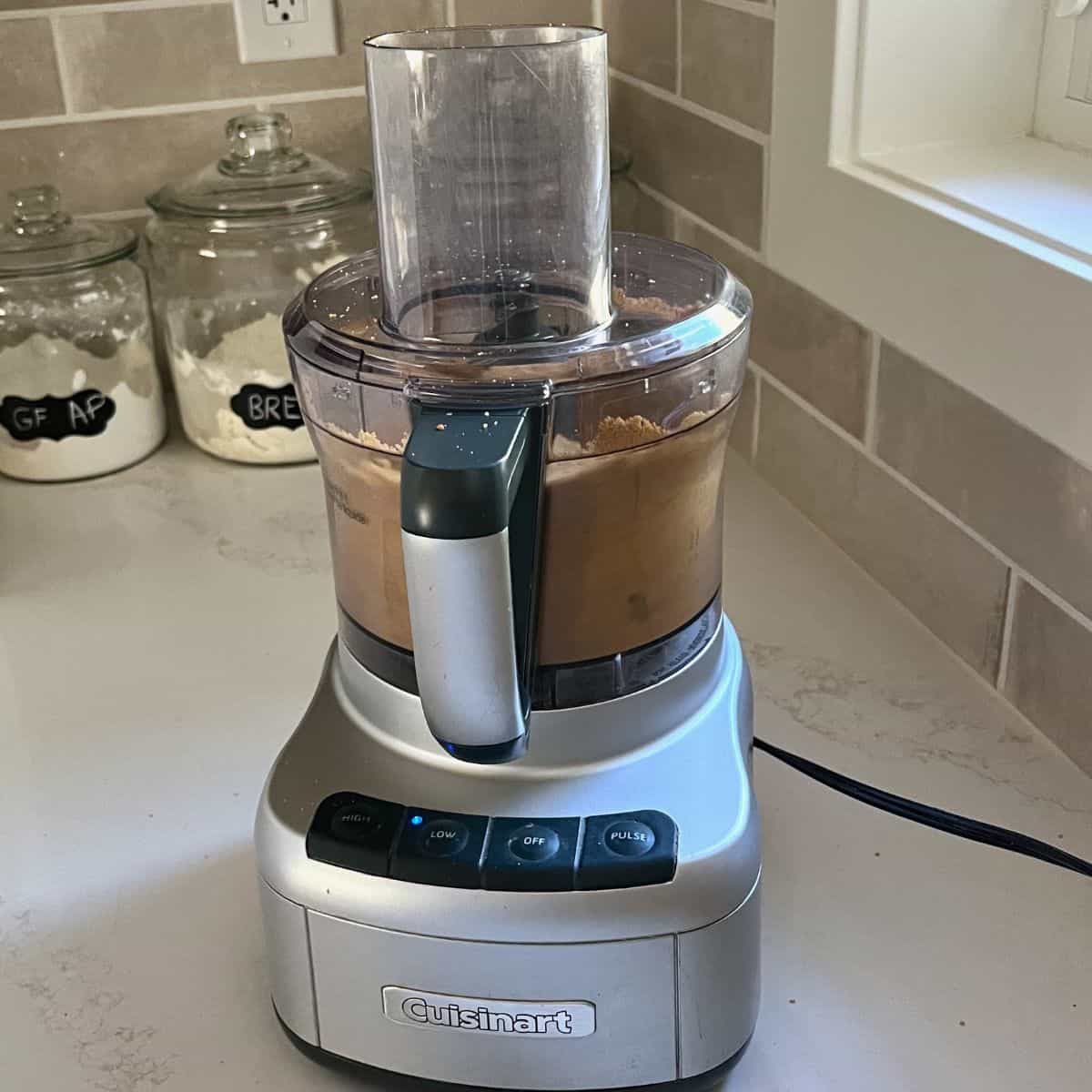food processor with fine crumbs in bowl.