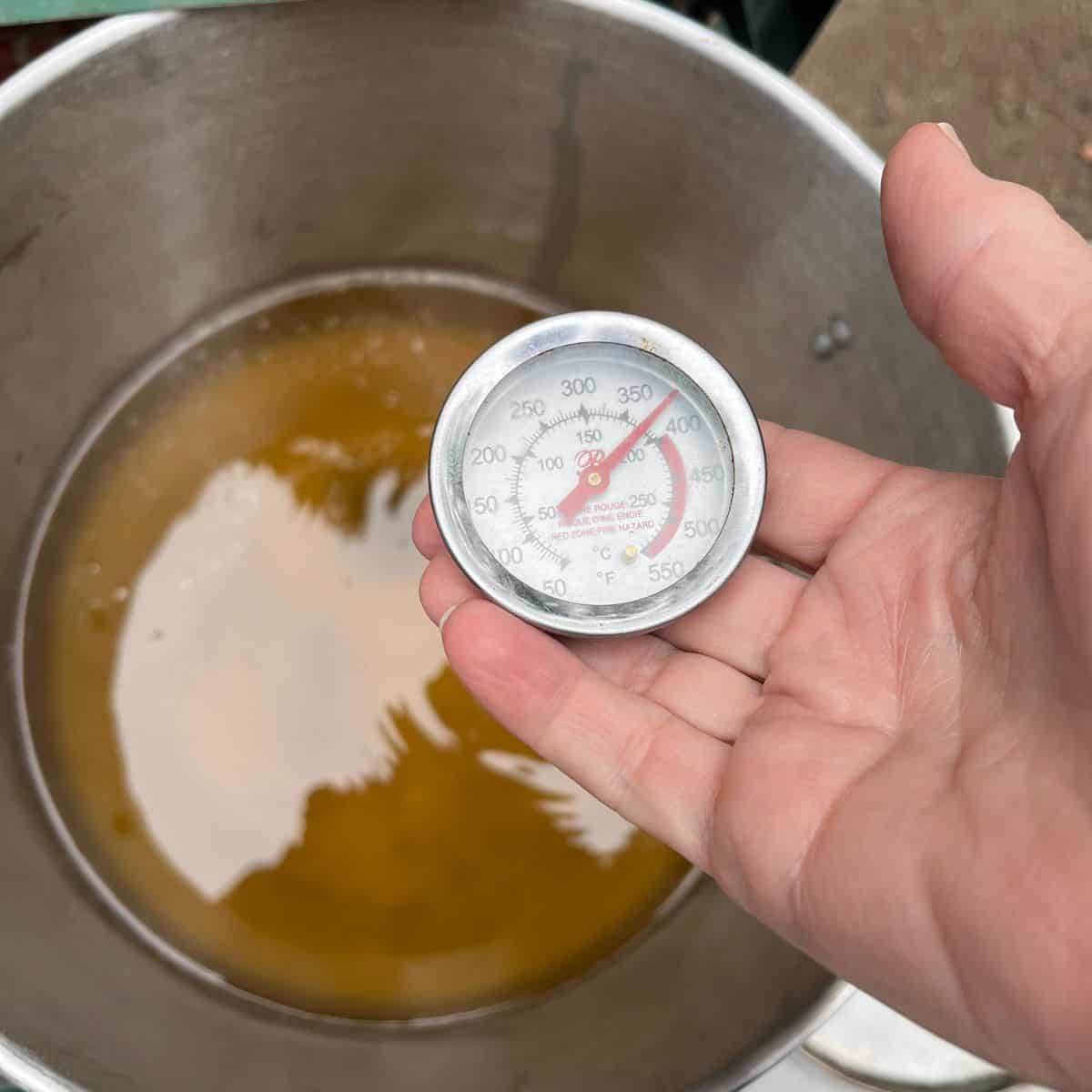 thermometer in hot oil shows 375 F.