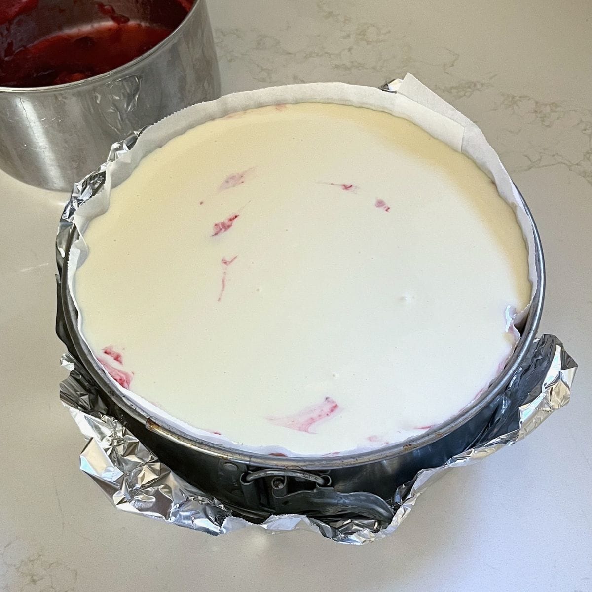 springform pan filled to the top with cream cheese mixture.