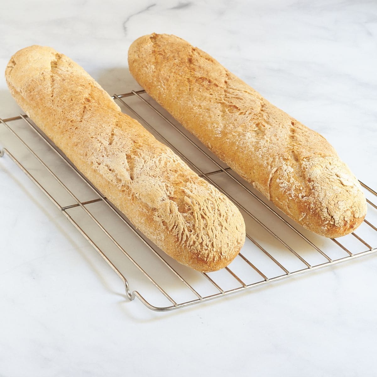 baguettes cooling on a wire rack.
