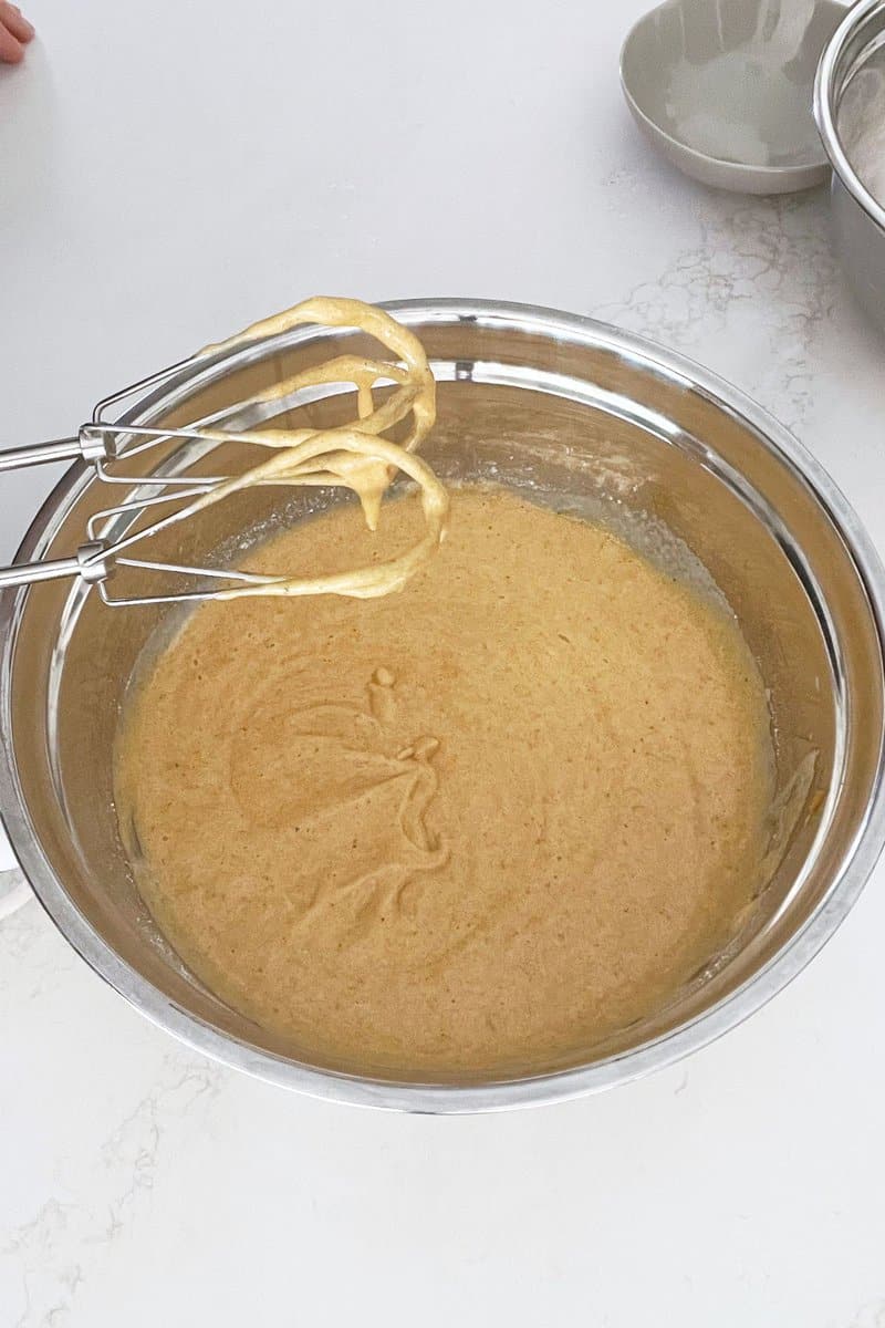 golden, pumpkin batter in mixing bowl.