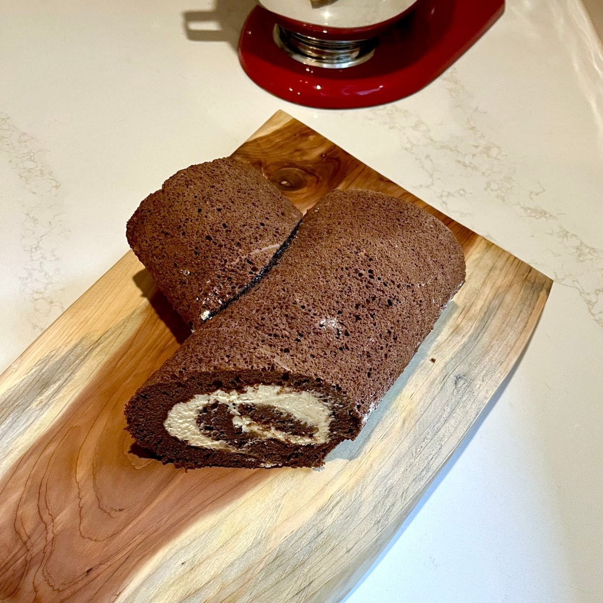 chocolate roll with the end cut off on a 45-degree angle and placed at side to form a branch.