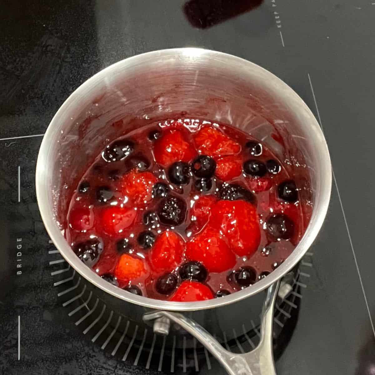 berry mixture in small saucepan with liquid.