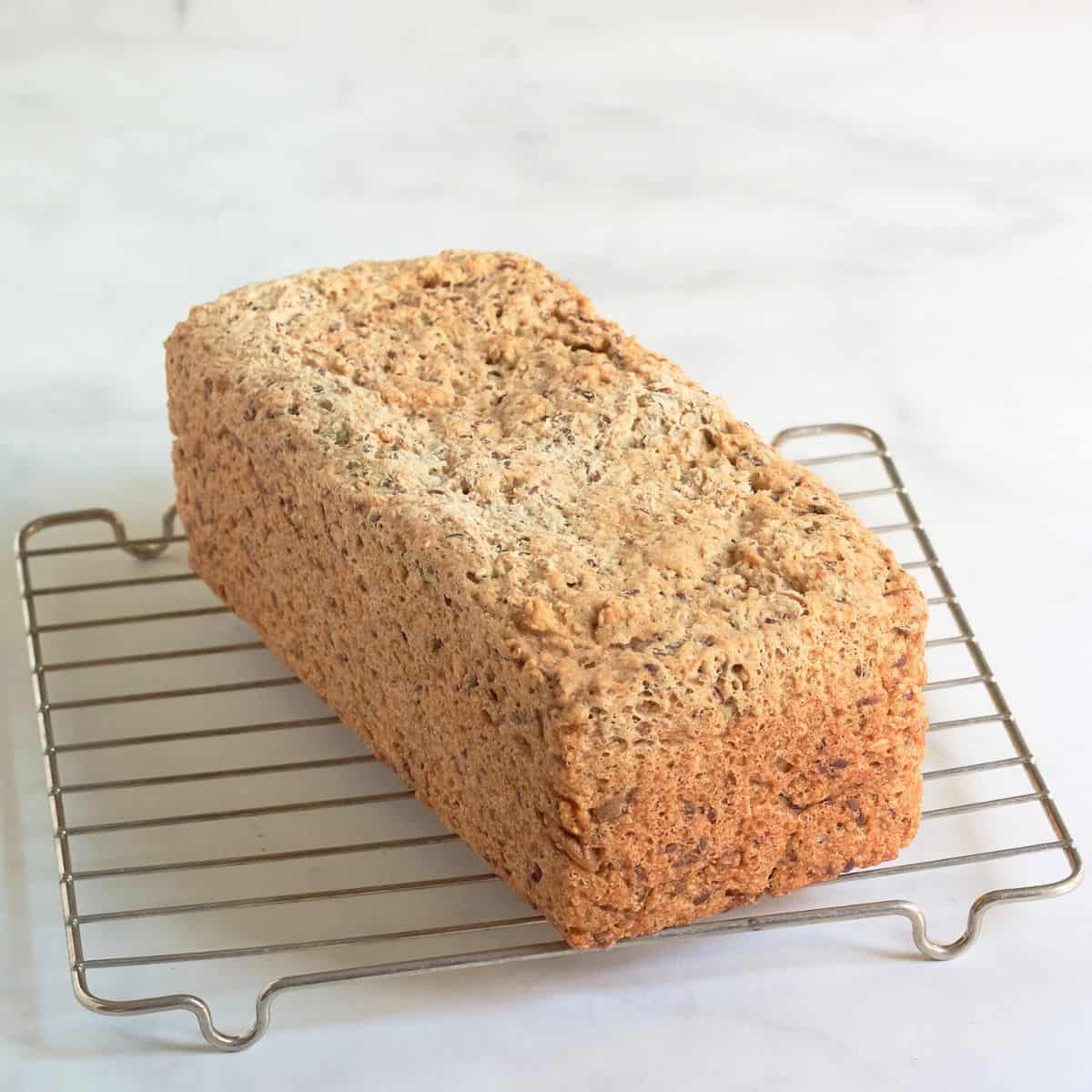 golden baked loaf cooling on wire rack.