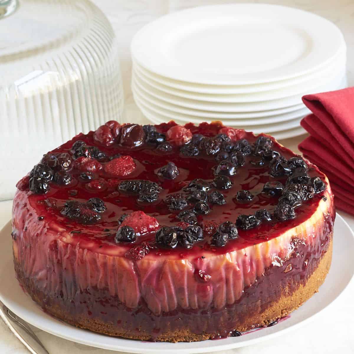 whole cheesecake with berry sauce poured over the top.