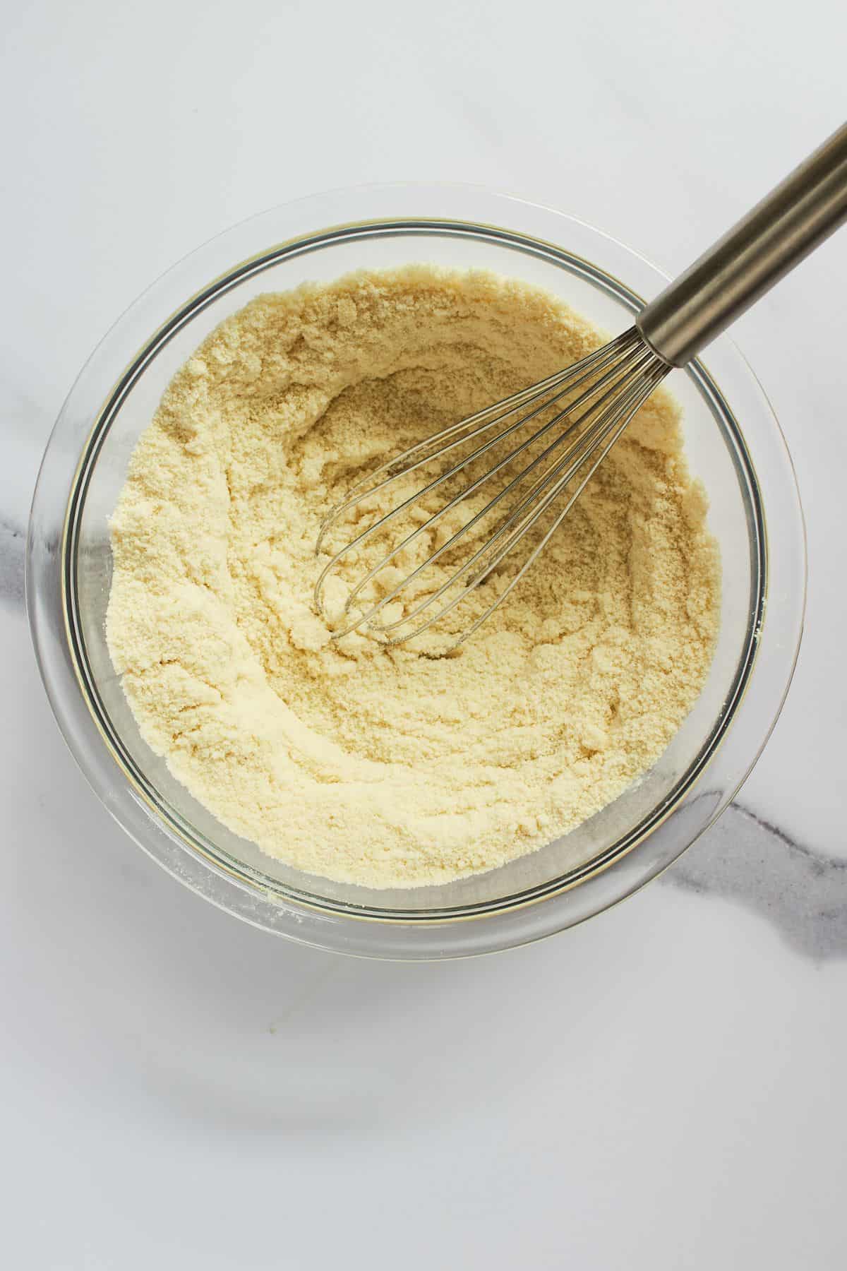 dry, almond flour mixture with whisk in glass bowl.