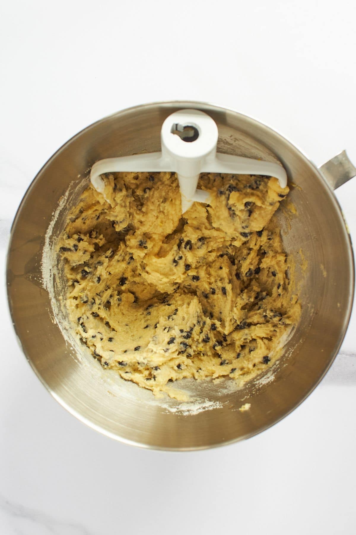 moist, sticky batter studded with dried blueberries in mixing bowl