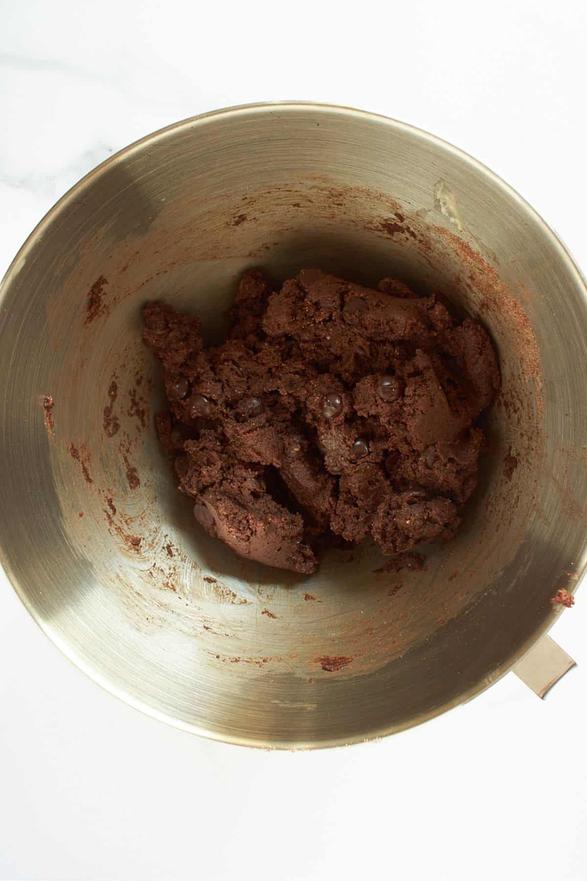 dark, chocolate batter in a rough ball in bowl.