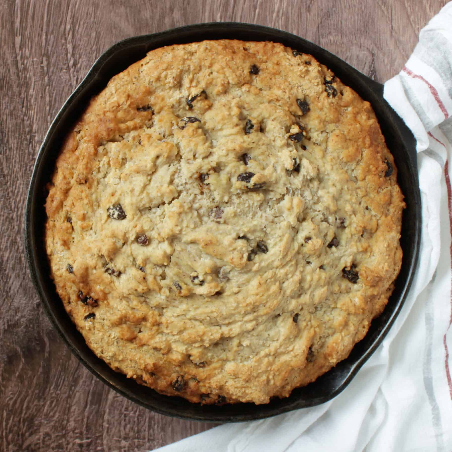 overhead view of baked gluten-free irish soda bread in a cast iron skillet.