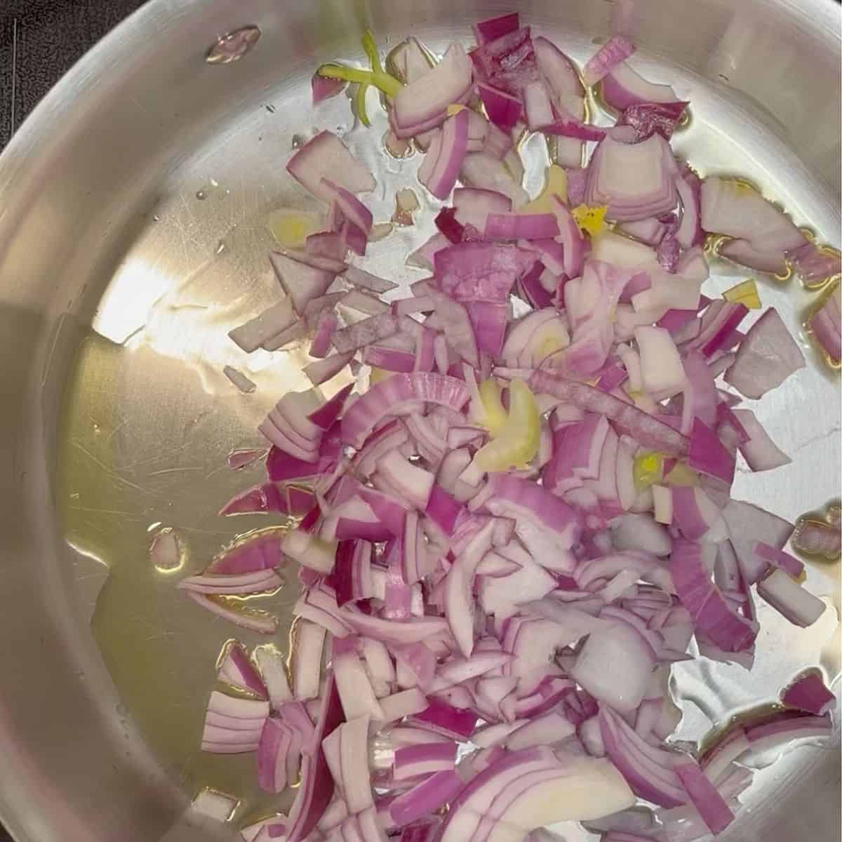 chopped onion frying in a pan.