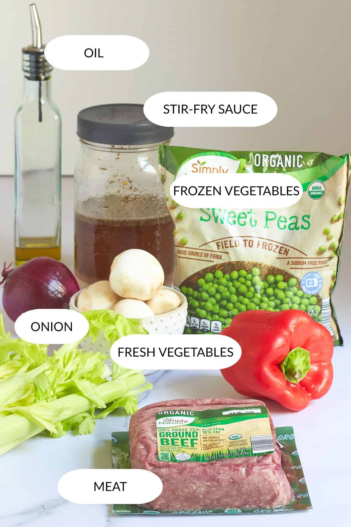 jar of broth, frozen peas, red pepper, mushrooms , celery, ground beef, with labels.