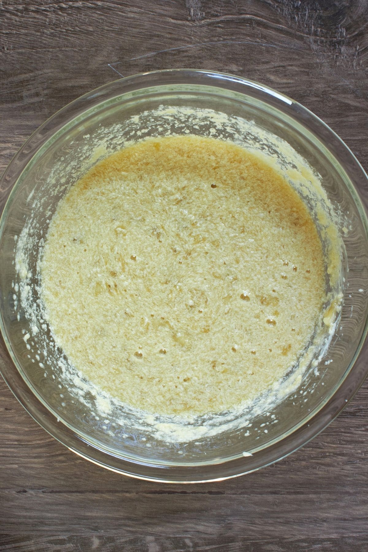 beaten wet liquid in glass bowl.