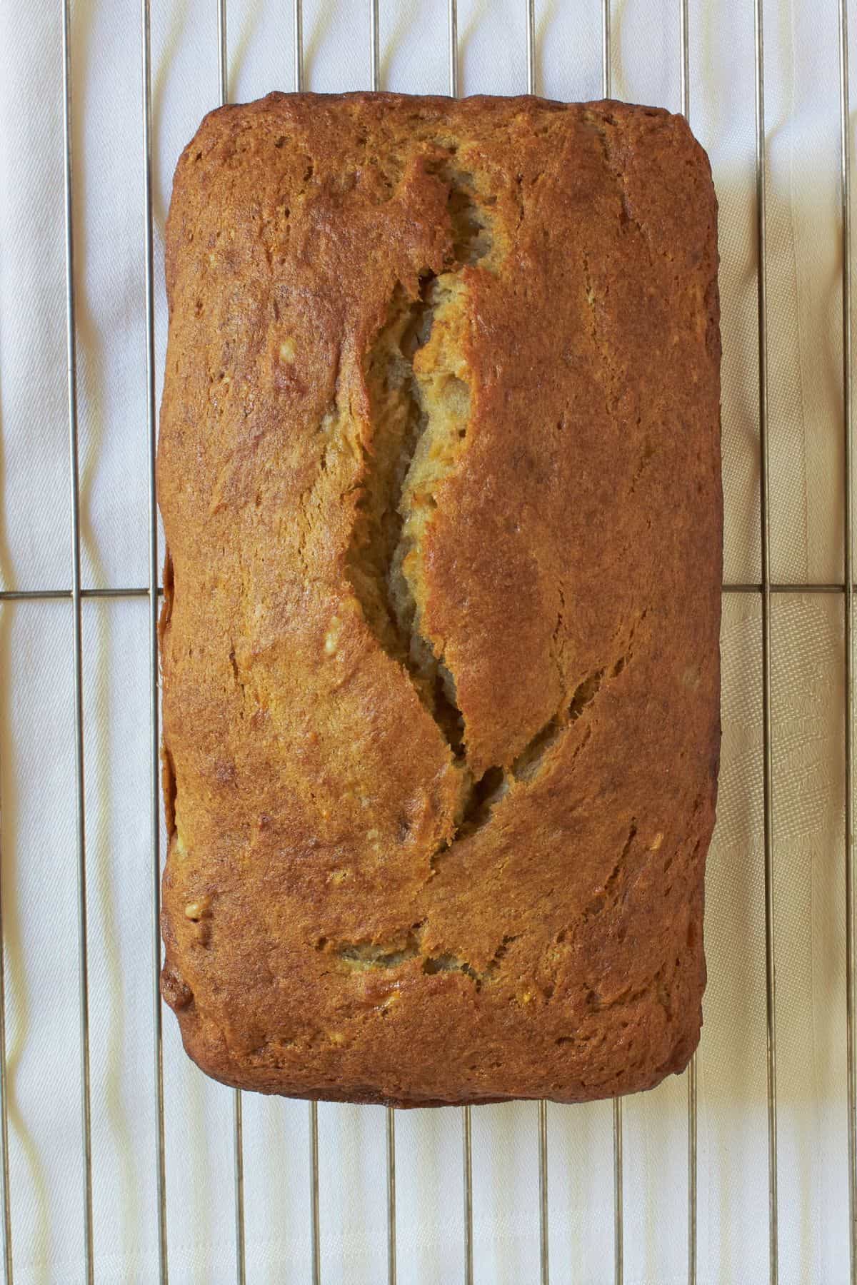 overhead view of baked gluten-free banana bread on cooling rack.